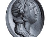 a close up of a coin with a woman ' s head on it