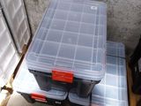 two plastic boxes sitting on top of a pallet