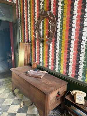 a wooden table with a phone on it in a room