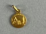 a close up of a gold coin on a white surface
