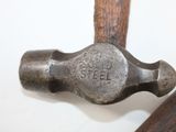 a hammer that is sitting on top of a wooden stick