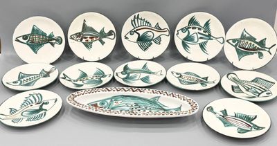 beaucoup d'assiettes avec du poisson dessus sur une table