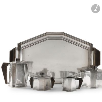 a silver plated tea set with four cups and a tray