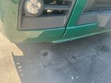 a close up of the front of a green pick up truck
