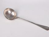 a silver spoon with a spoon handle on a white surface