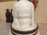 a statue of a person sitting on a table