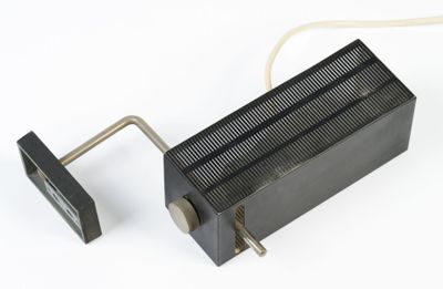 a black heat plate with a wire attached to it
