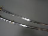 a close up of two swords on display on a table