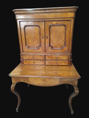 une vieille armoire en bois surmontée de deux tiroirs