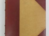 brown and yellow leather book with a yellow triangle on top of it