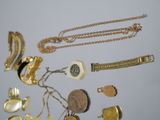 a lot of gold and silver jewelry on a table