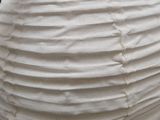 a white paper lantern hanging from the ceiling