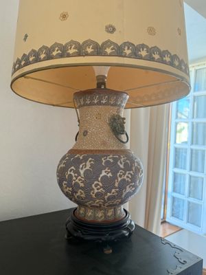a lamp that is sitting on a table in front of a window