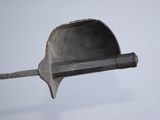 a metal scoop with a handle on a pole
