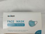 two boxes of disposable face masks sitting on a table