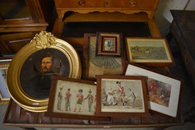 a lot of framed pictures and pictures on a table