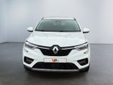 the front view of a white car in a white room