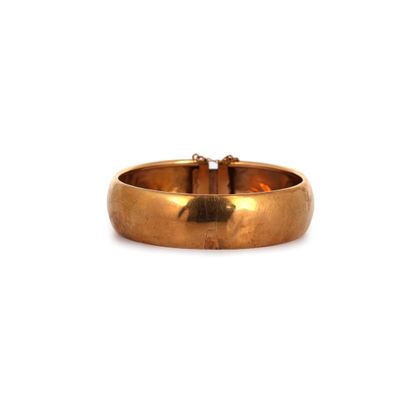 gros plan d'une bague en or sur fond blanc