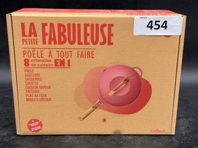 a box that has a pink bowl and a wooden spoon in it
