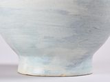 a blue and white bowl sitting on a white surface