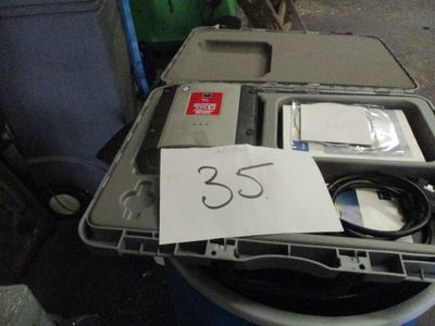 a box that has a laptop and a charger in it