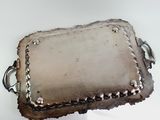 a silver tray with a chain around it on a table