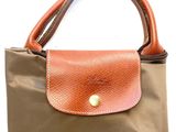 an image of a brown and tan purse on a white background