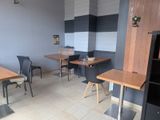 tables and chairs are lined up in a room with gray walls