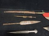 many different types of knives on a black surface