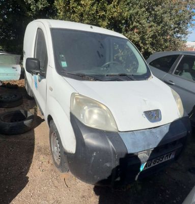 a white van that is parked next to other cars