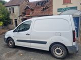 a white van that is parked in front of a building