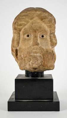 sculpture of a man ' s head on a black stand