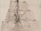 a glass chandelier hanging from the ceiling in a room