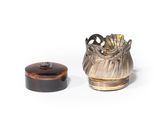 a small vase and a small box on a white surface