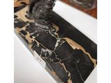 a close up of a statue of a horse on a marble base