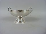 an image of a silver bowl on a stand on a white surface