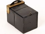 a small black box with a wooden handle on a white surface