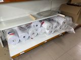 many rolls of toilet paper on a shelf in a store
