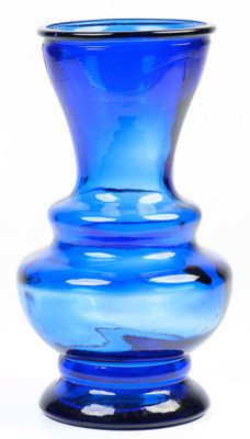 a blue glass vase that is sitting on a table
