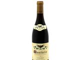 a bottle of wine sitting on top of a white table