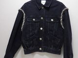 the jacket is hanging on a hanger on the wall