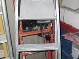 a ladder that is leaning against a wall in a room