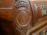 a wooden chest of drawers with ornate carvings on it