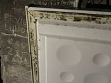 graffiti on the wall of a bathroom with a toilet and a toilet paper dispenser