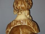 statue of a bust of a woman on a wooden base