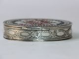a silver box with a red and white design on it