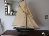 a small sailboat on a dresser in a room