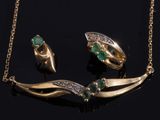 an image of a gold necklace and earring set with emeralds