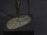 a bronze statue of a horse on a black base