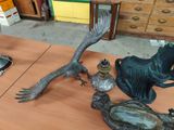 a statue of a woman and a bird sitting on a table